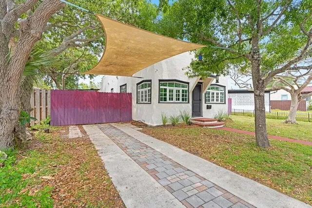 a front view of a house with garden