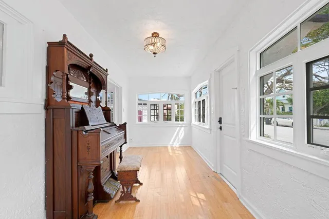 a view of a livingroom with furniture workspace window and hallway