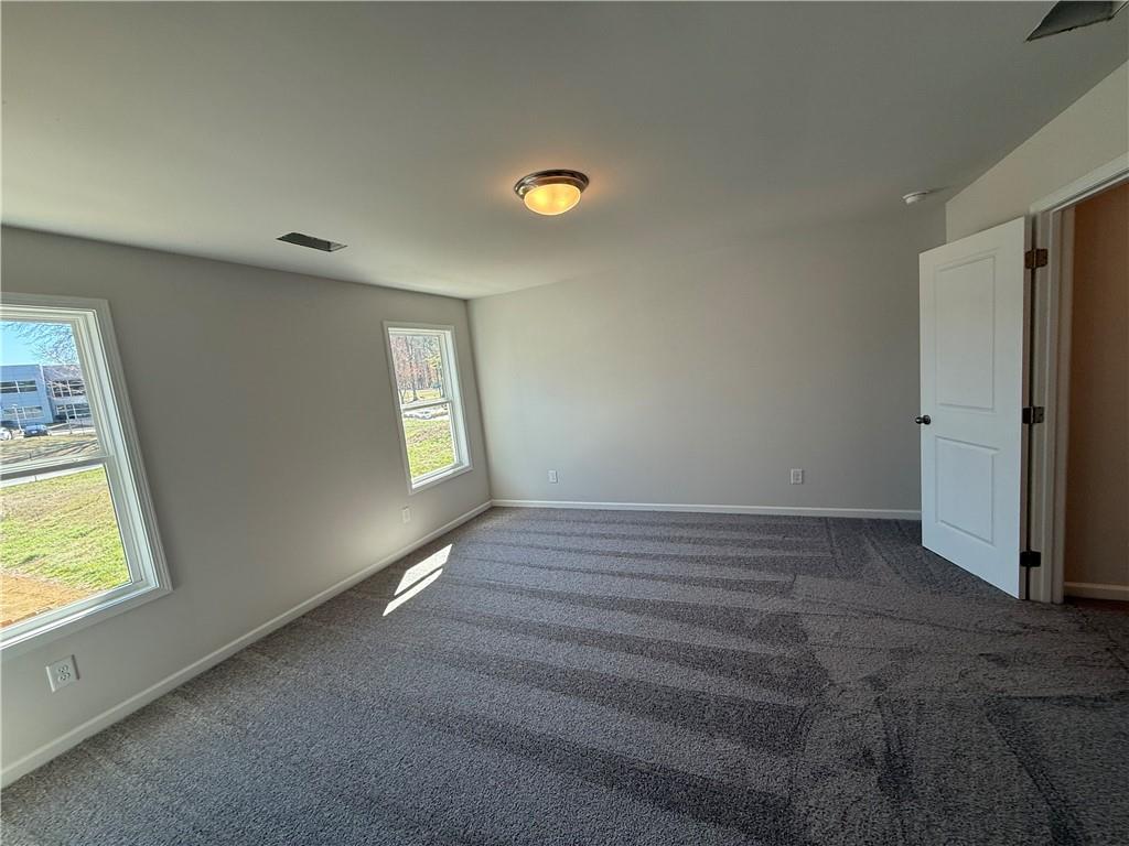 5143 Longview Run Decatur, GA 30035 - Photo 13 of 17 a view of an empty room with window and wooden floor