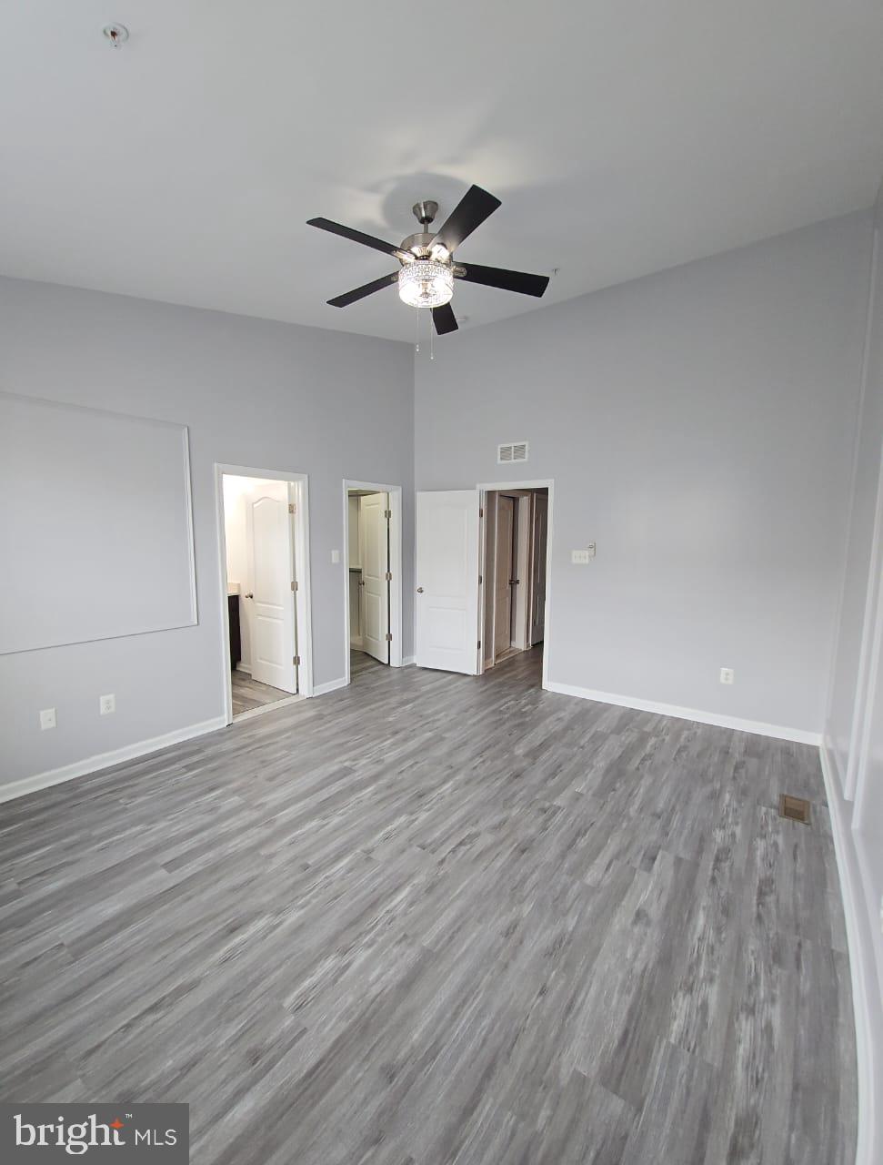211 Spring Bank Avenue Frederick, MD 21701 - Photo 14 of 24 a view of an empty room with a ceiling fan and wooden floor