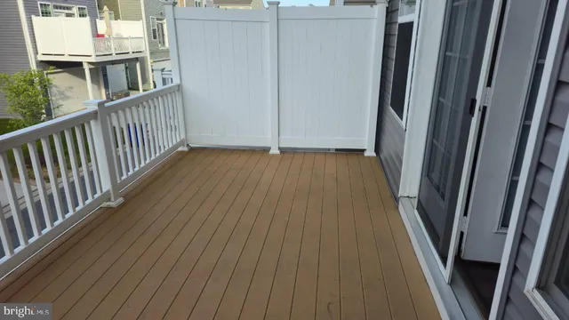 a view of balcony with wooden floor