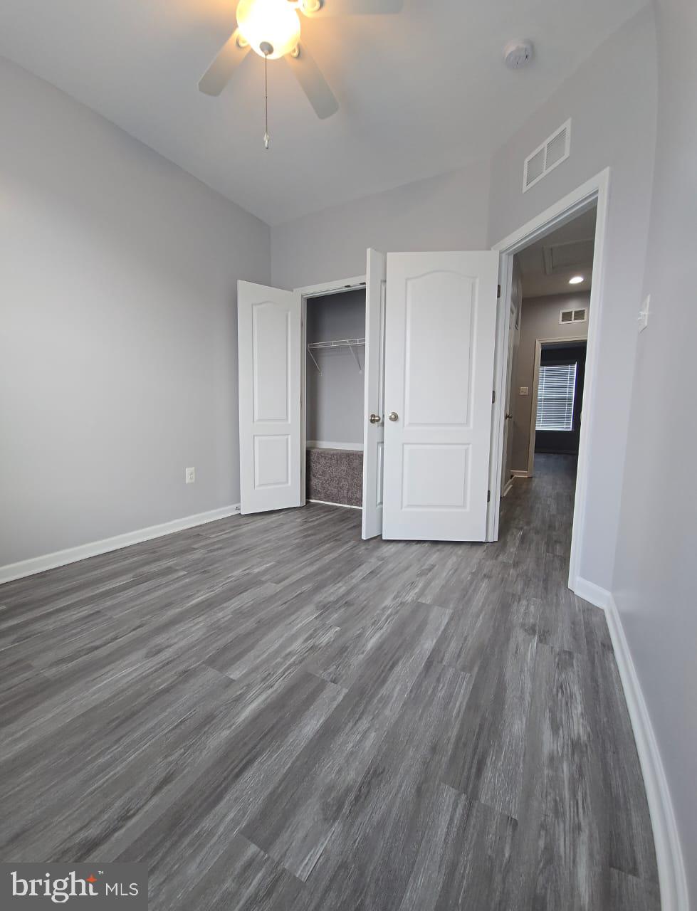 211 Spring Bank Avenue Frederick, MD 21701 - Photo 22 of 24 wooden floor in an empty room with a window