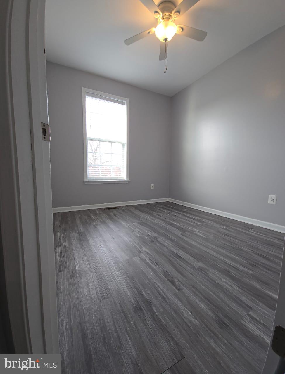 211 Spring Bank Avenue Frederick, MD 21701 - Photo 23 of 24 an empty room with wooden floor and windows