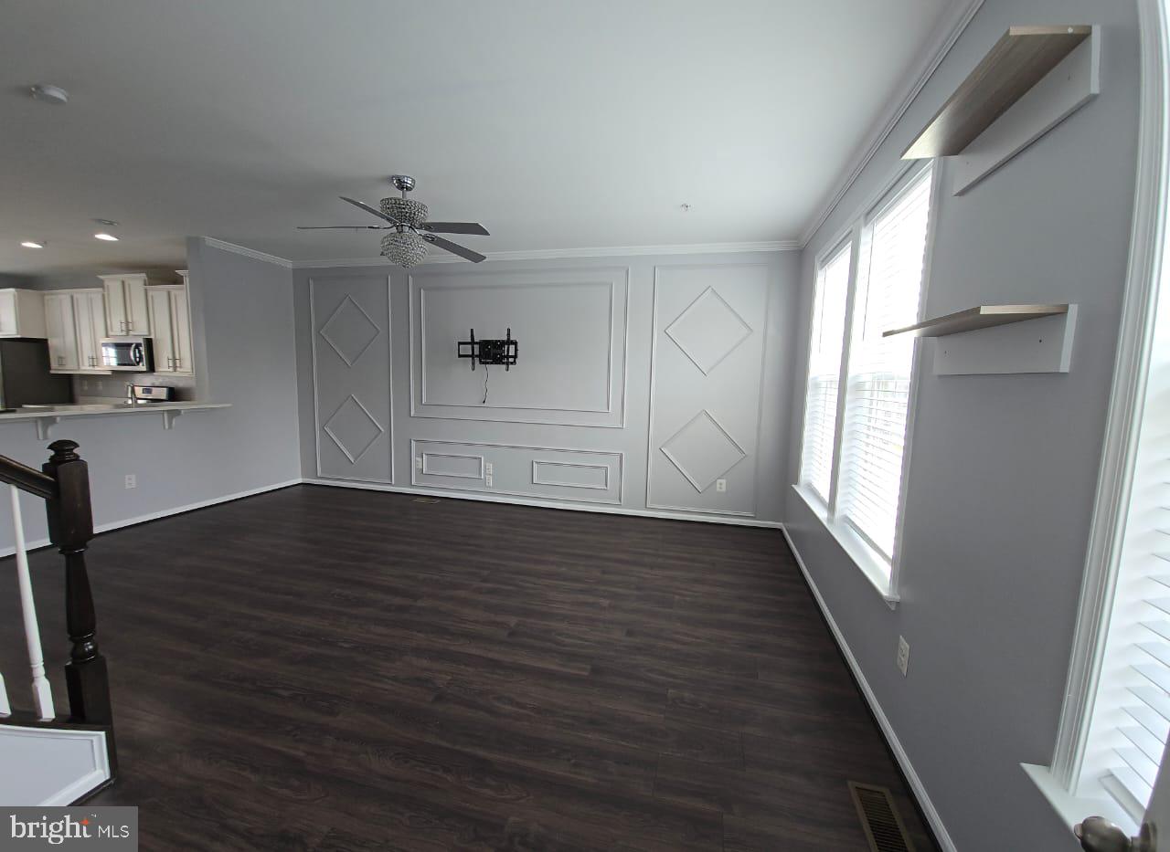 211 Spring Bank Avenue Frederick, MD 21701 - Photo 4 of 24 wooden floor in an empty room with a window