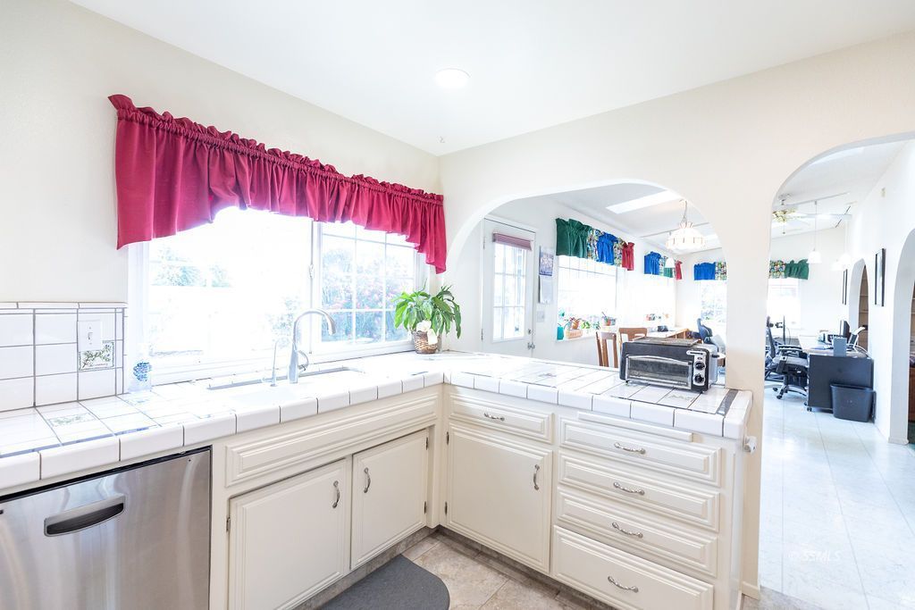 737 Scott Circle Ridgecrest, CA 93555 - Photo 14 of 49 a kitchen with granite countertop a sink and white cabinets