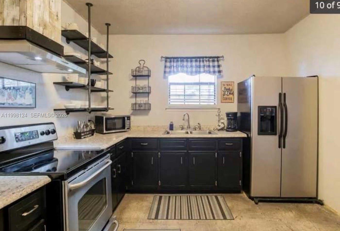 1005 Lakewood Road Pensacola, FL 32507 - Photo 12 of 23 a kitchen with a sink stove and refrigerator