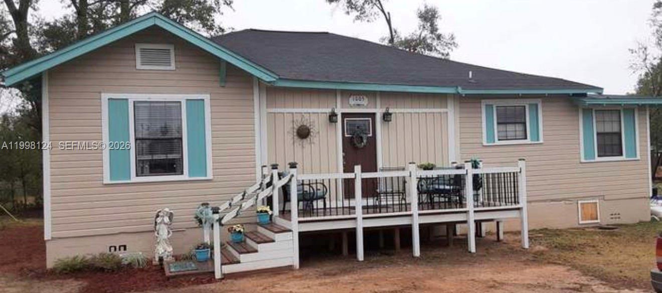 1005 Lakewood Road Pensacola, FL 32507 - Photo 2 of 23 a front view of a house with a chairs and table in a patio