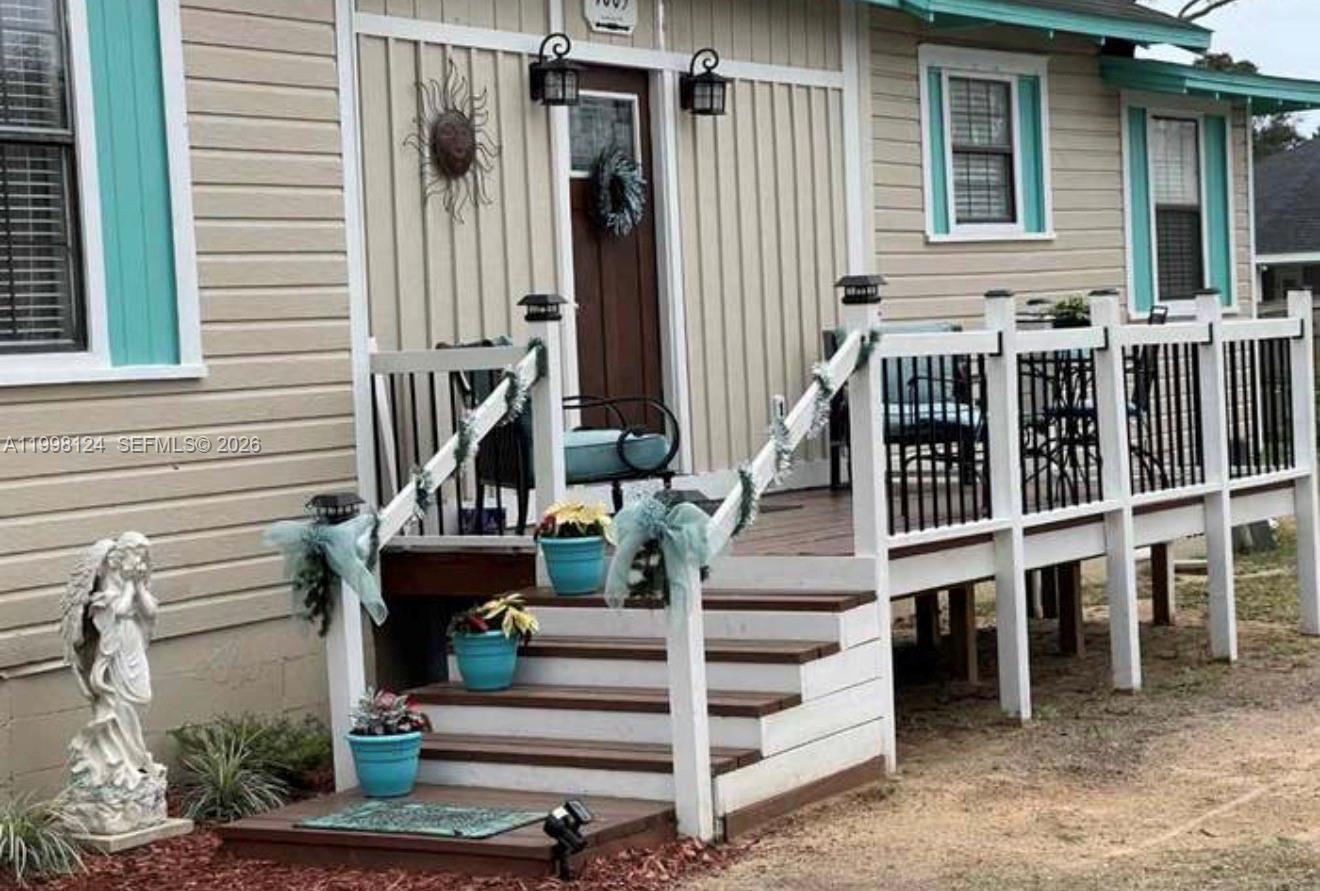 1005 Lakewood Road Pensacola, FL 32507 - Photo 22 of 23 a view of wooden house with a large windows and stairs