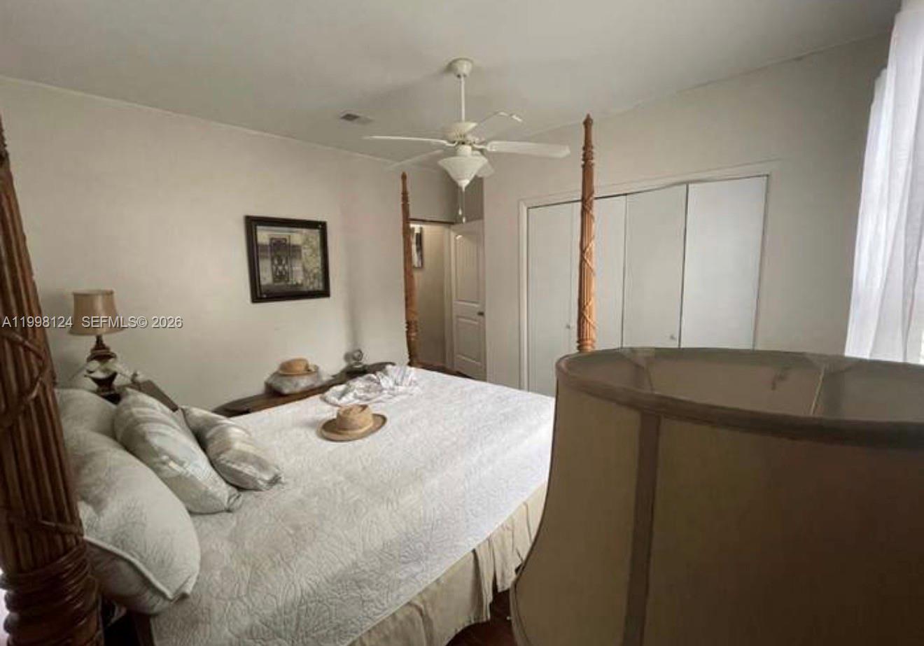 1005 Lakewood Road Pensacola, FL 32507 - Photo 5 of 23 a bedroom with a bed and a chandelier