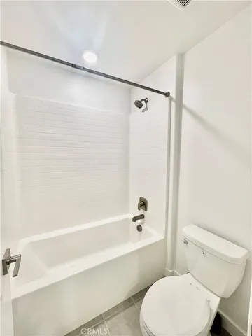 a bathroom with a toilet and a bathtub