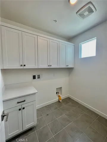 a view of a kitchen with white cabinets