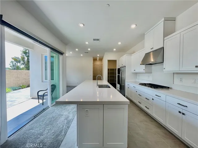 a large kitchen with stainless steel appliances kitchen island a large island in the center