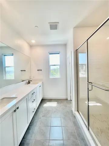 a bathroom with a granite countertop sink a mirror and a bathtub