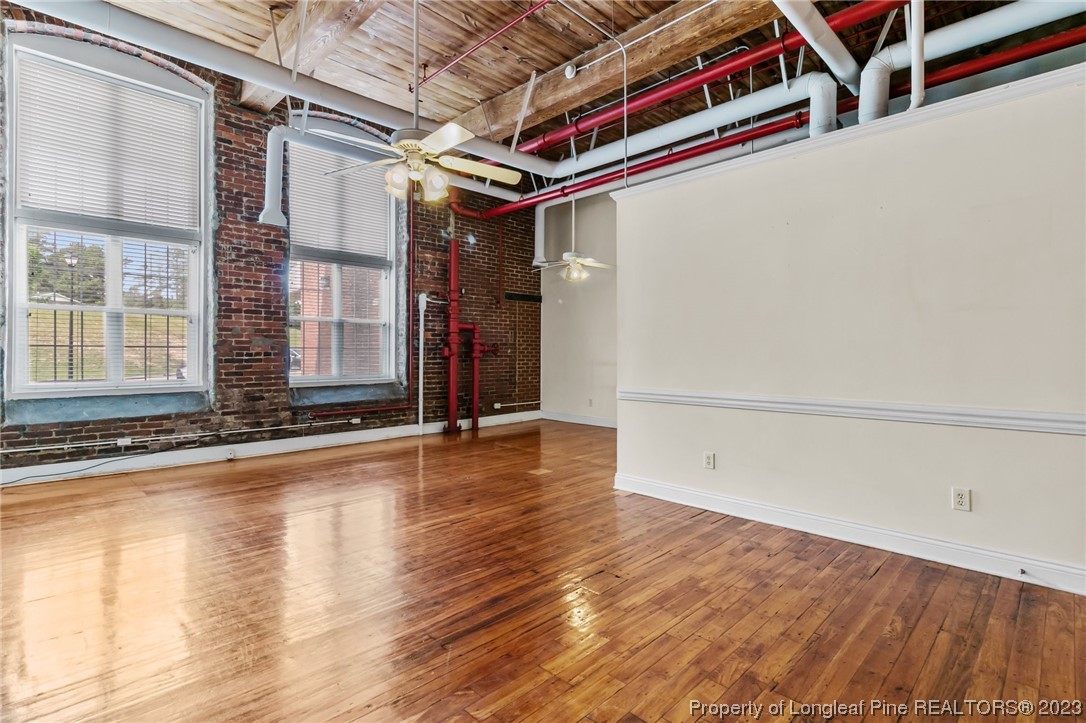 100 Carolyns Mill Place Rockingham, NC 28379 - Photo 22 of 30 an empty room with wooden floor and windows