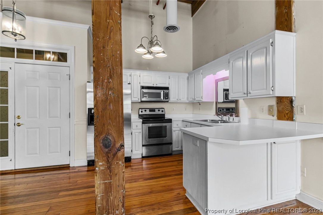 100 Carolyns Mill Place Rockingham, NC 28379 - Photo 23 of 30 a kitchen with kitchen island granite countertop a stove top oven a sink and cabinets