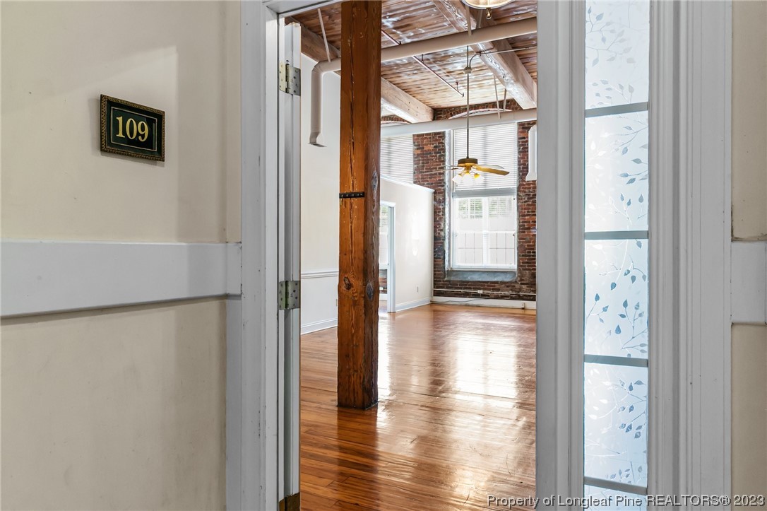 100 Carolyns Mill Place Rockingham, NC 28379 - Photo 25 of 30 a view of a hallway with wooden floor and dining room view