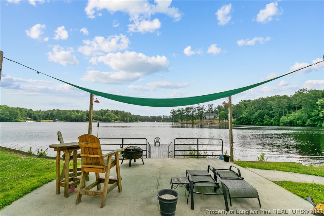 100 Carolyns Mill Place Rockingham, NC 28379 - Photo 30 of 30 a view of a lake with couches in patio