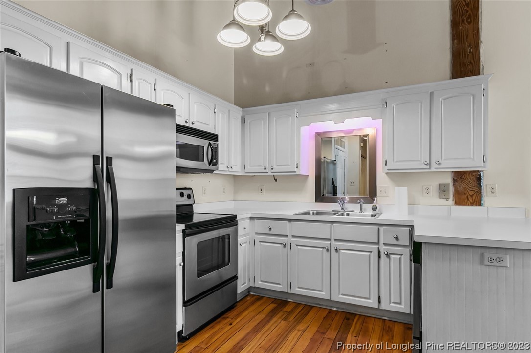100 Carolyns Mill Place Rockingham, NC 28379 - Photo 9 of 30 a kitchen with stainless steel appliances a sink stove and refrigerator