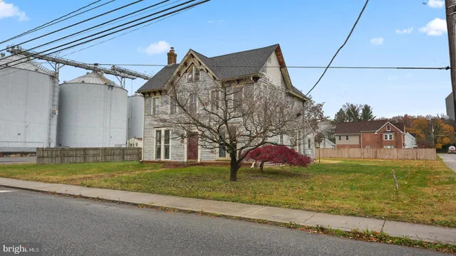 a view of a house with a yard and sitting area