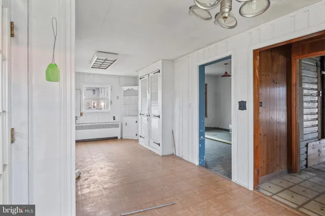 a view of a hallway with entryway and closet