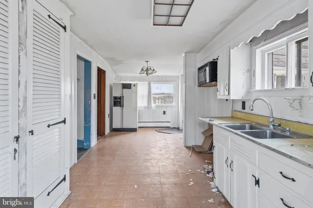 a view of a kitchen with a sink stove and cabinets