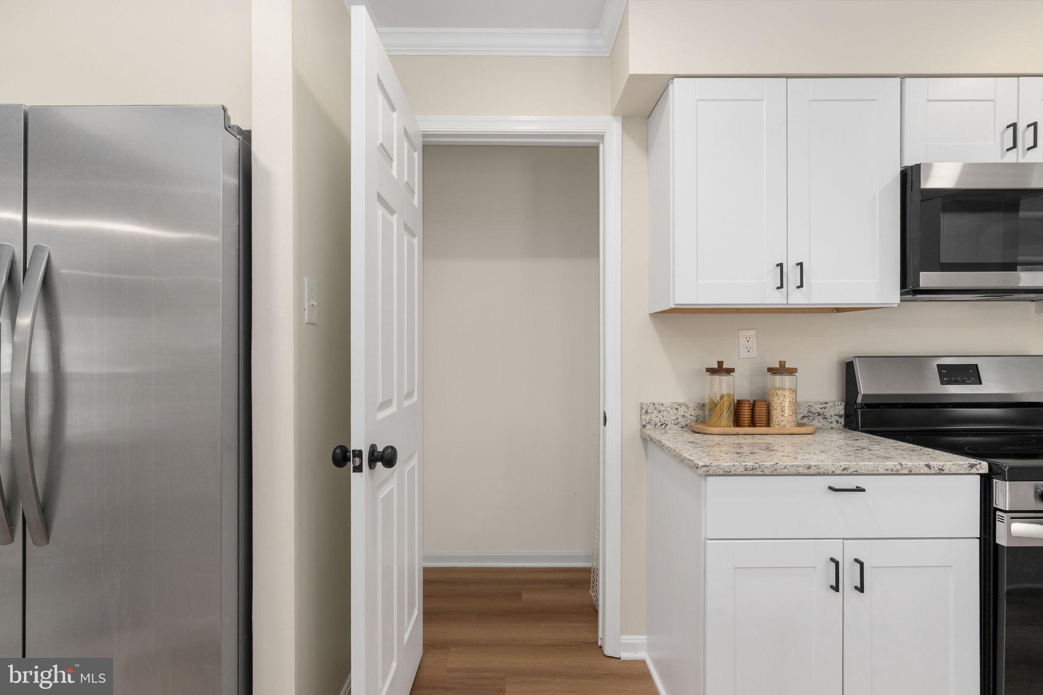 3234 Riverview Drive Triangle, VA 22172 - Photo 13 of 61 a kitchen with stainless steel appliances white cabinets and a refrigerator