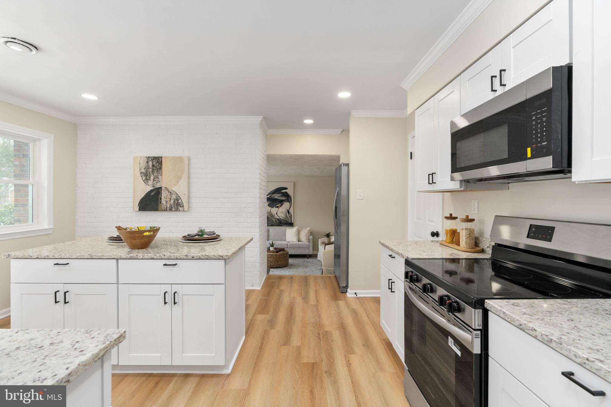 3234 Riverview Drive Triangle, VA 22172 - Photo 14 of 61 a kitchen with stainless steel appliances a stove microwave and cabinets