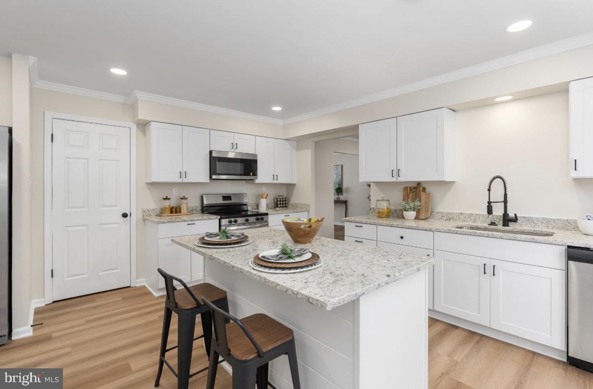 3234 Riverview Drive Triangle, VA 22172 - Photo 2 of 61 a kitchen with stainless steel appliances granite countertop a sink stove and cabinets