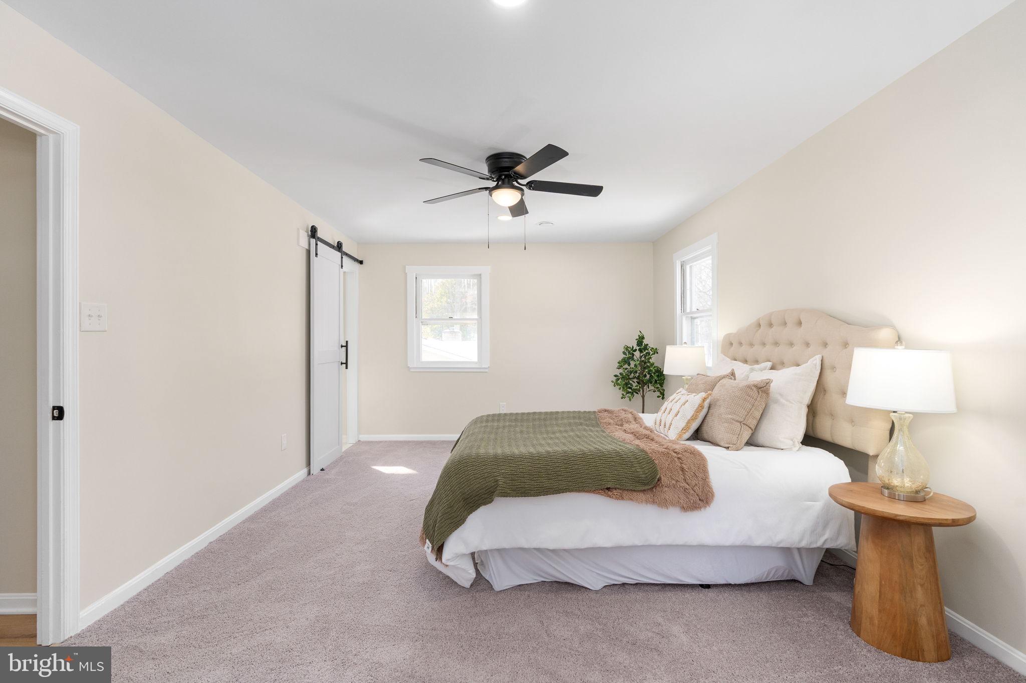 3234 Riverview Drive Triangle, VA 22172 - Photo 38 of 61 a spacious bedroom with a bed and a lamp