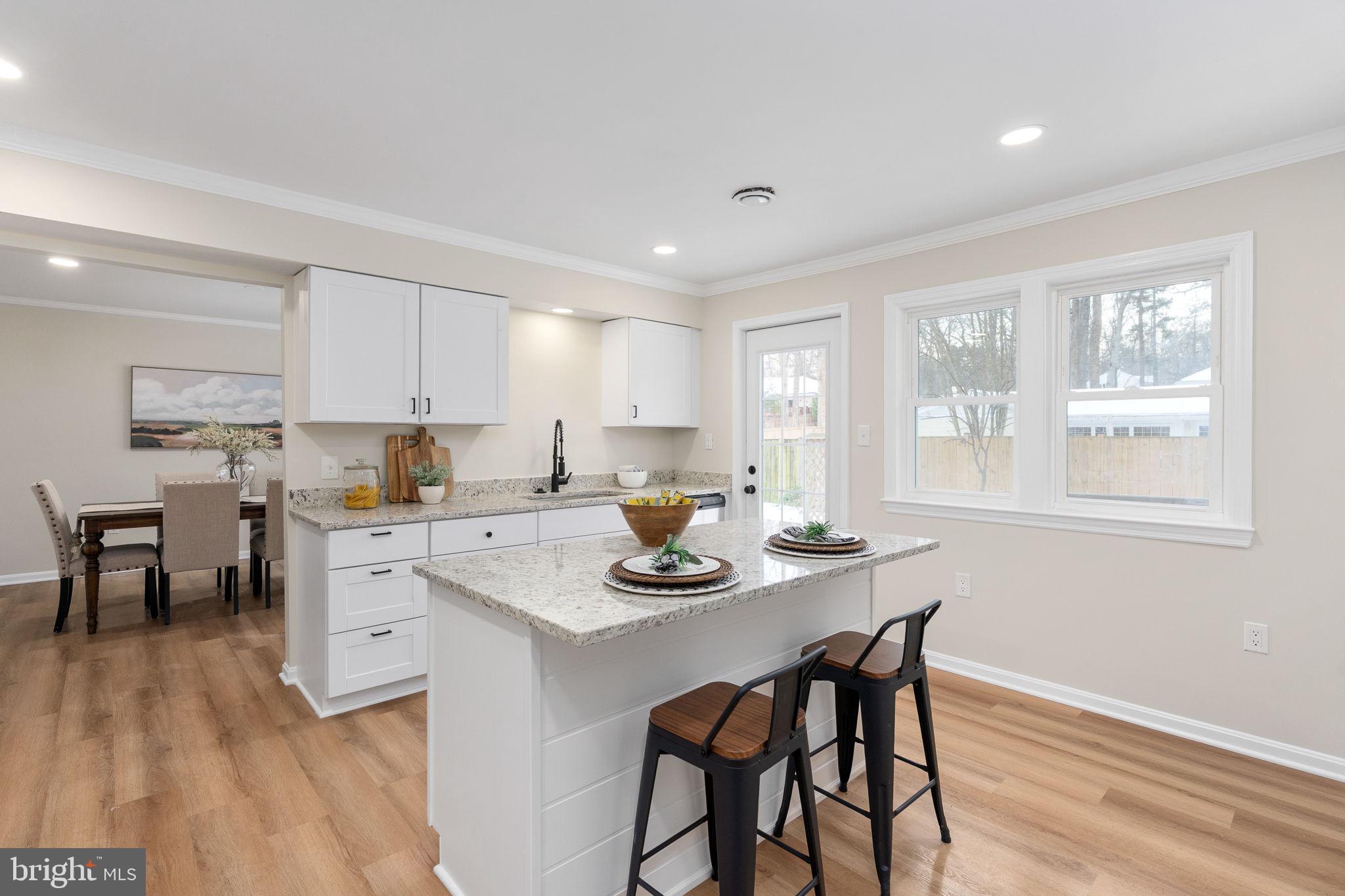 3234 Riverview Drive Triangle, VA 22172 - Photo 10 of 61 a kitchen with a dining table chairs and wooden floor