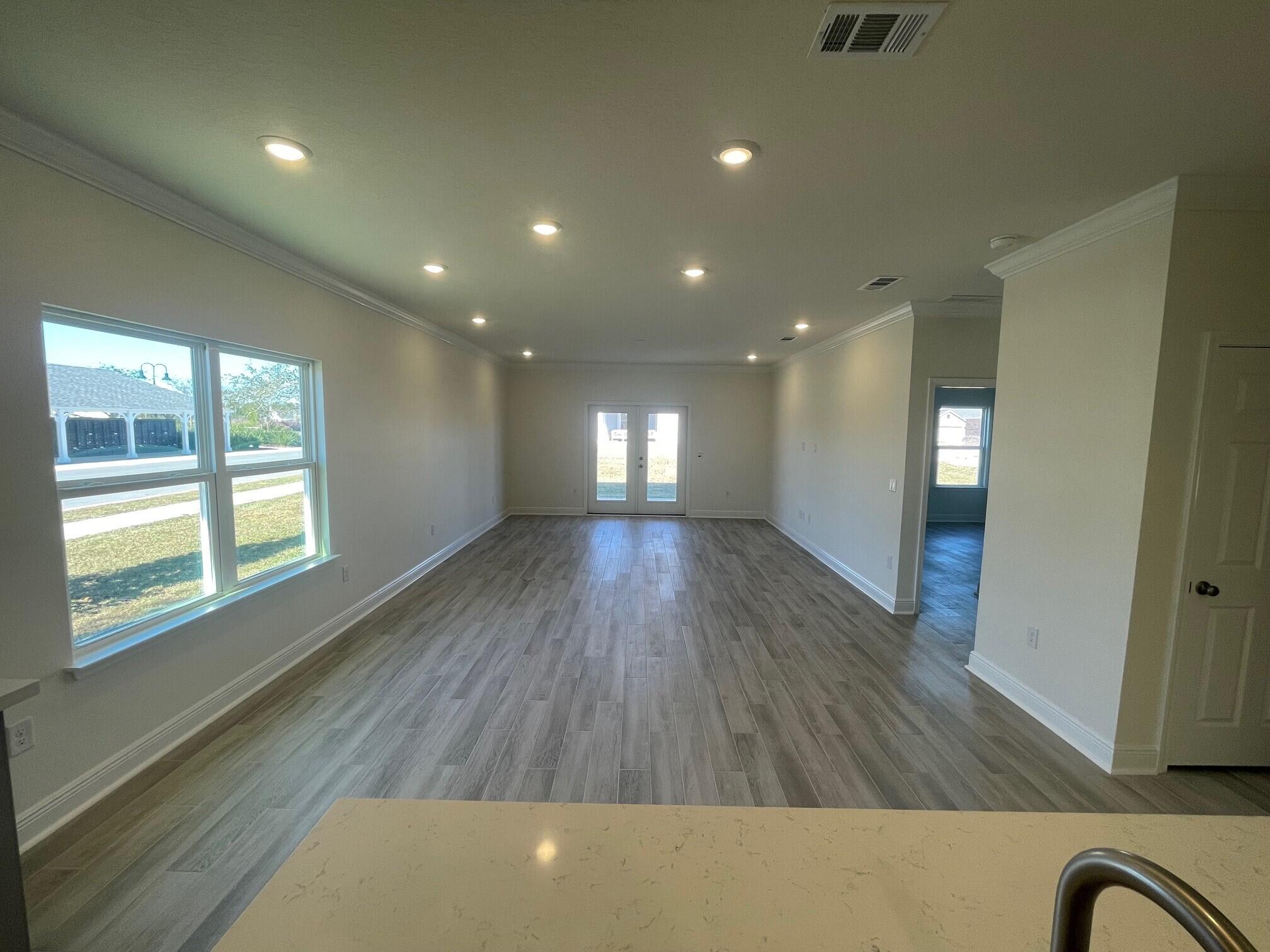 13 Splendor Run Ponce de Leon, FL 32455 - Photo 2 of 5 wooden floor in an empty room with a window