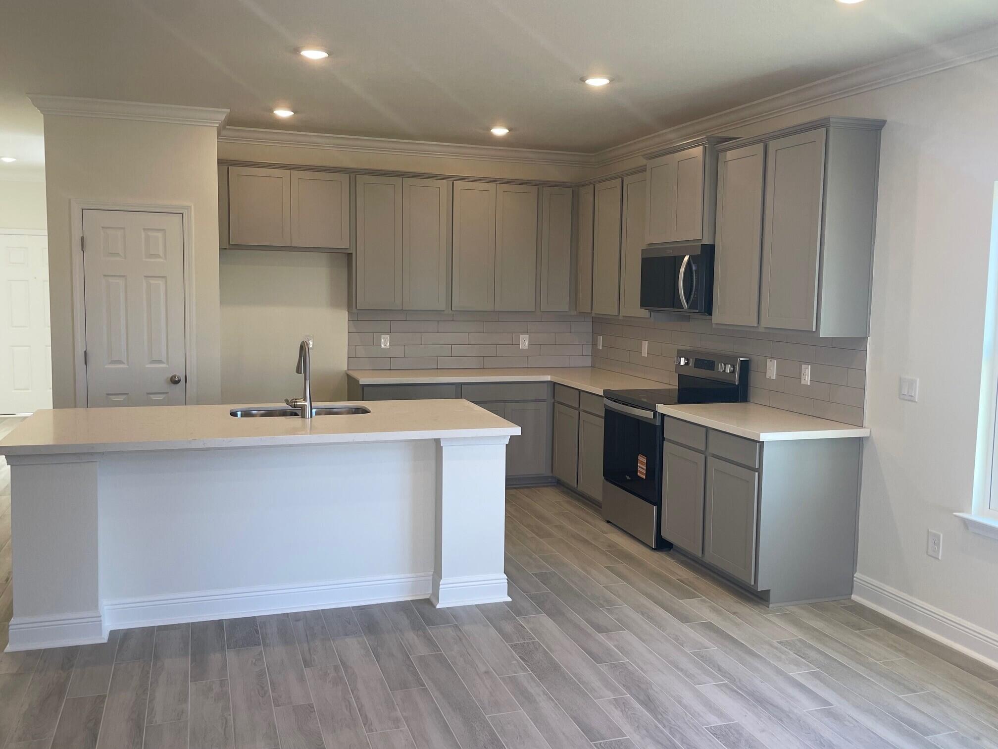 13 Splendor Run Ponce de Leon, FL 32455 - Photo 3 of 5 a kitchen with a sink cabinets and wooden floor