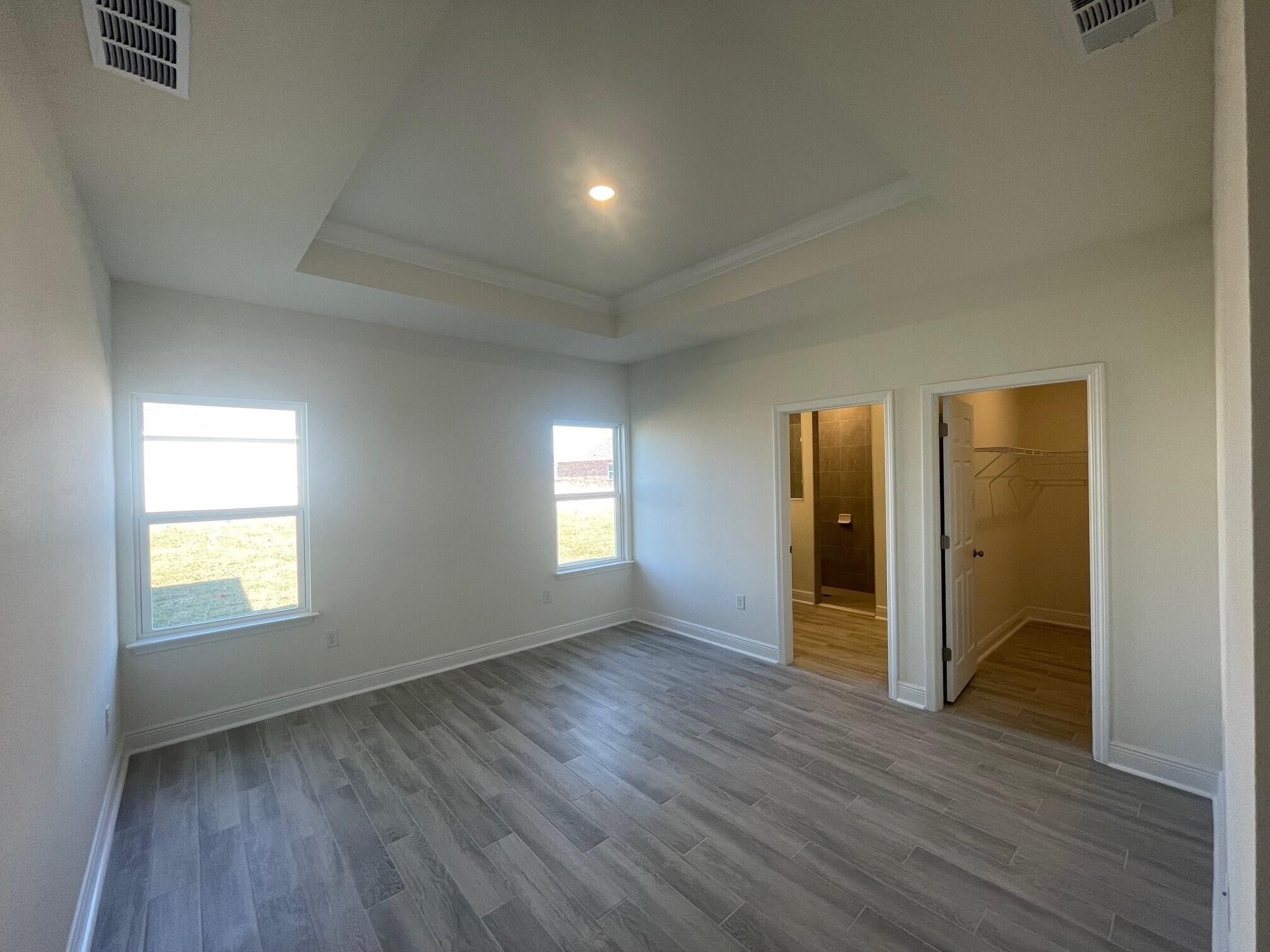 13 Splendor Run Ponce de Leon, FL 32455 - Photo 5 of 5 an empty room with wooden floor and windows