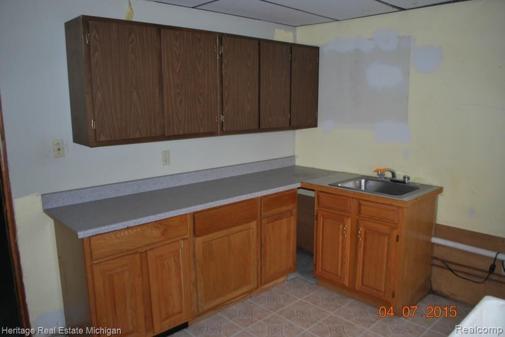 63 Endicott Howell, MI 48843 - Photo 13 of 39 cabinets in utility in bsmt