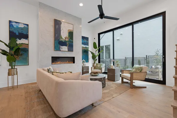 a living room with furniture and large windows