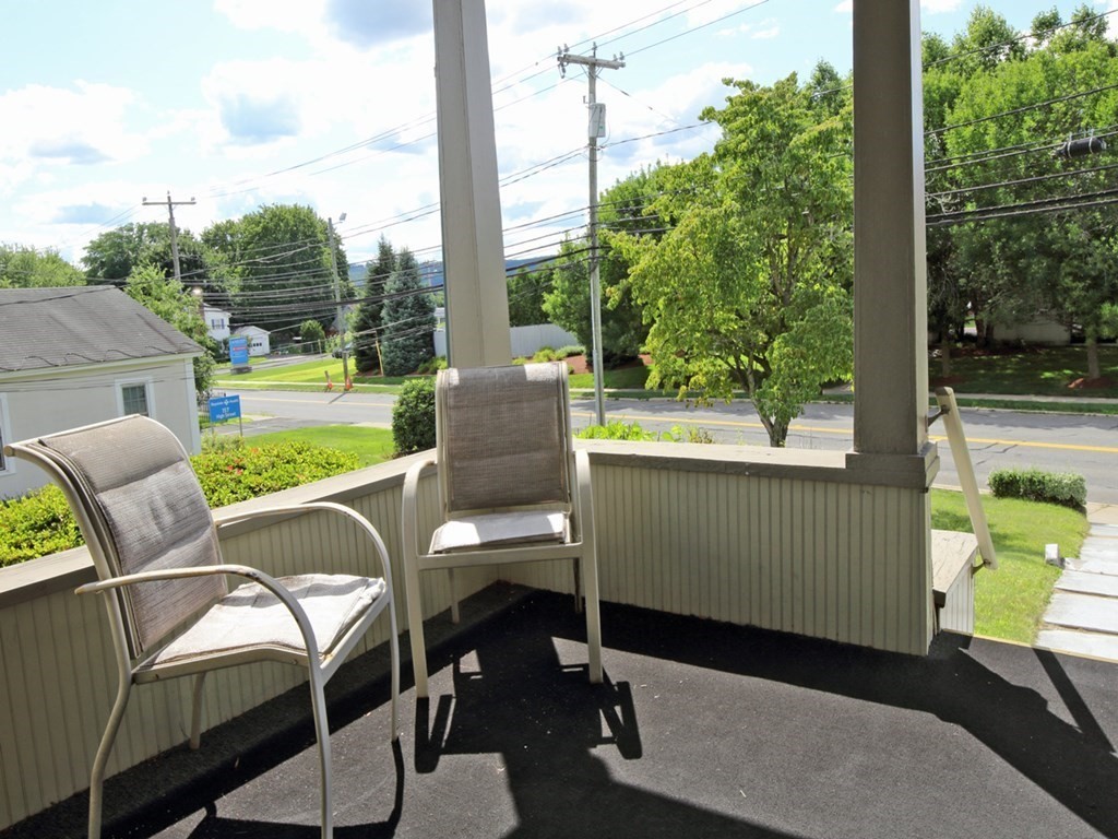 161 High Street Greenfield, MA 01301 - Photo 20 of 42 a view of a porch with furniture and a yard