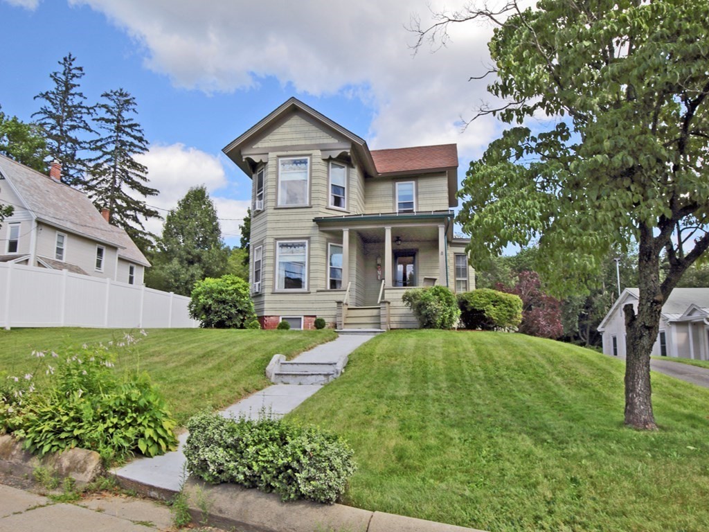 161 High Street Greenfield, MA 01301 - Photo 3 of 42 a front view of a house with a yard