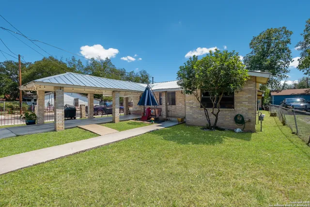 a view of a house with a backyard porch and sitting area