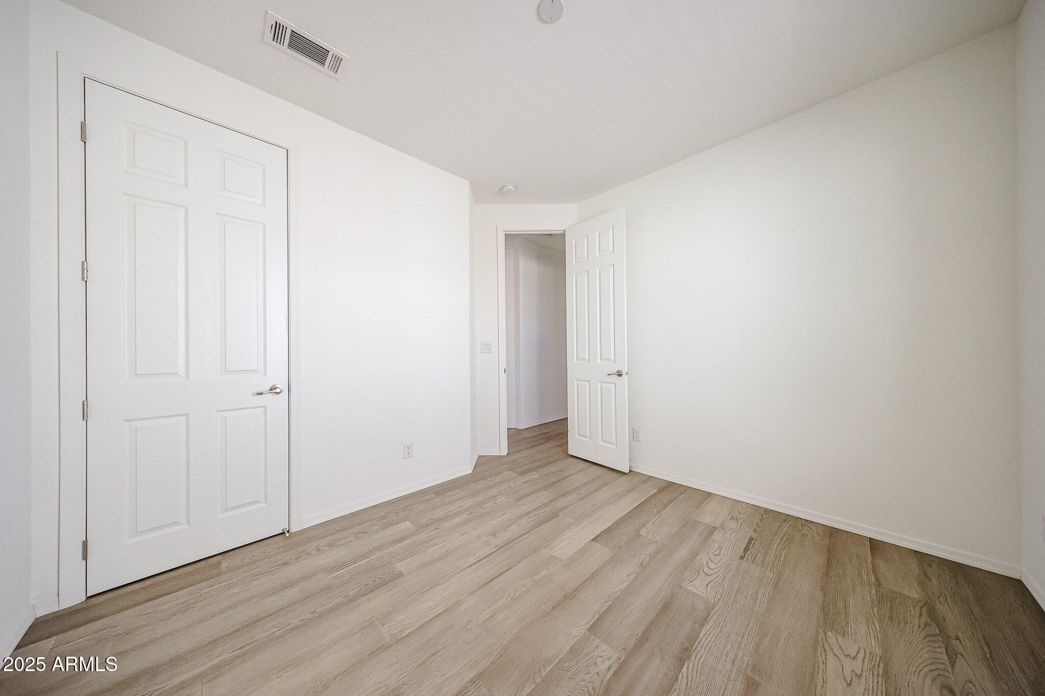 16101 North El Mirage Road, Unit 16 El Mirage, AZ 85335 - Photo 16 of 25 a view of an empty room with wooden floor
