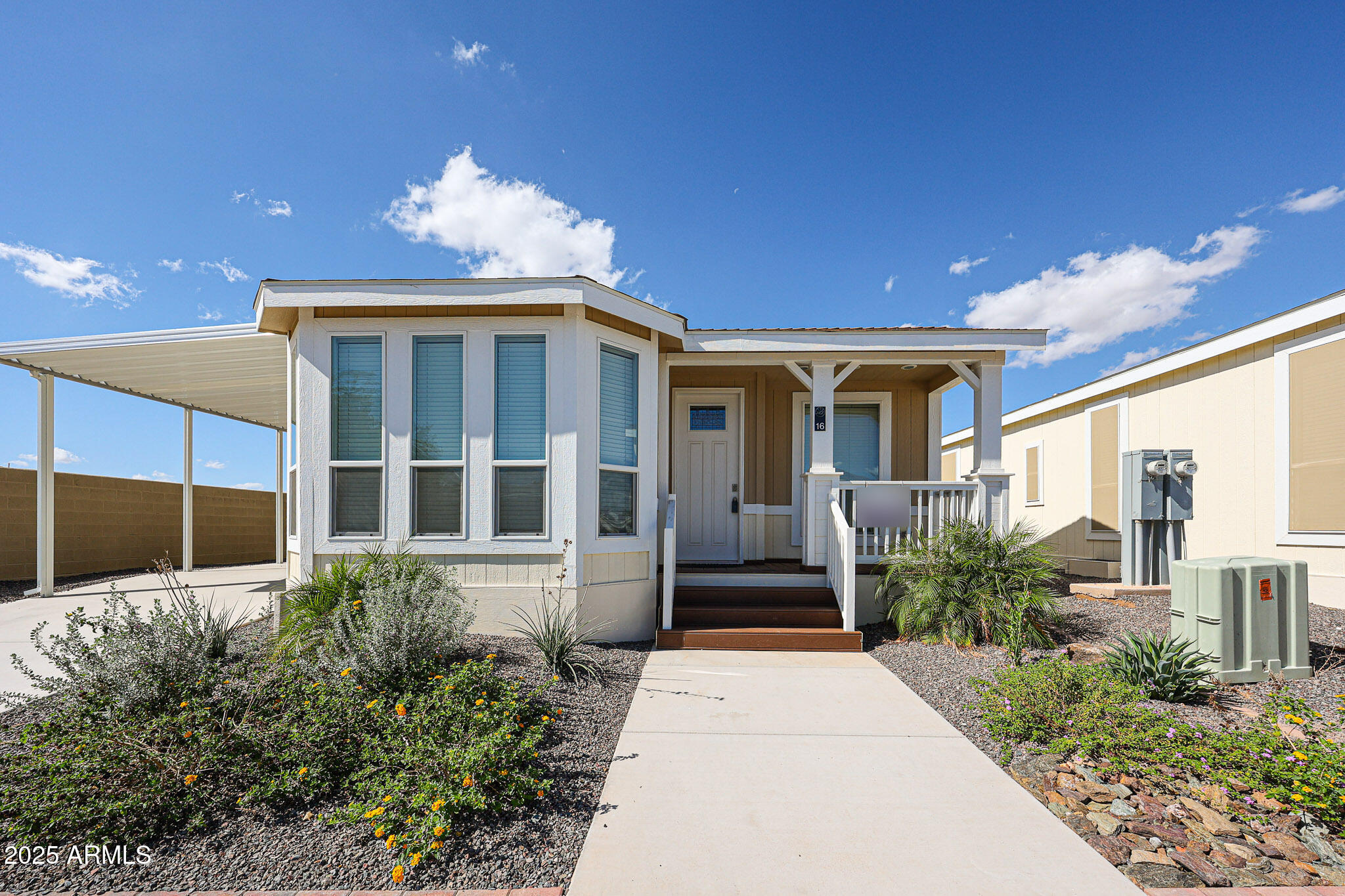 16101 North El Mirage Road, Unit 16 El Mirage, AZ 85335 - Photo 23 of 25 a front view of a house with a yard