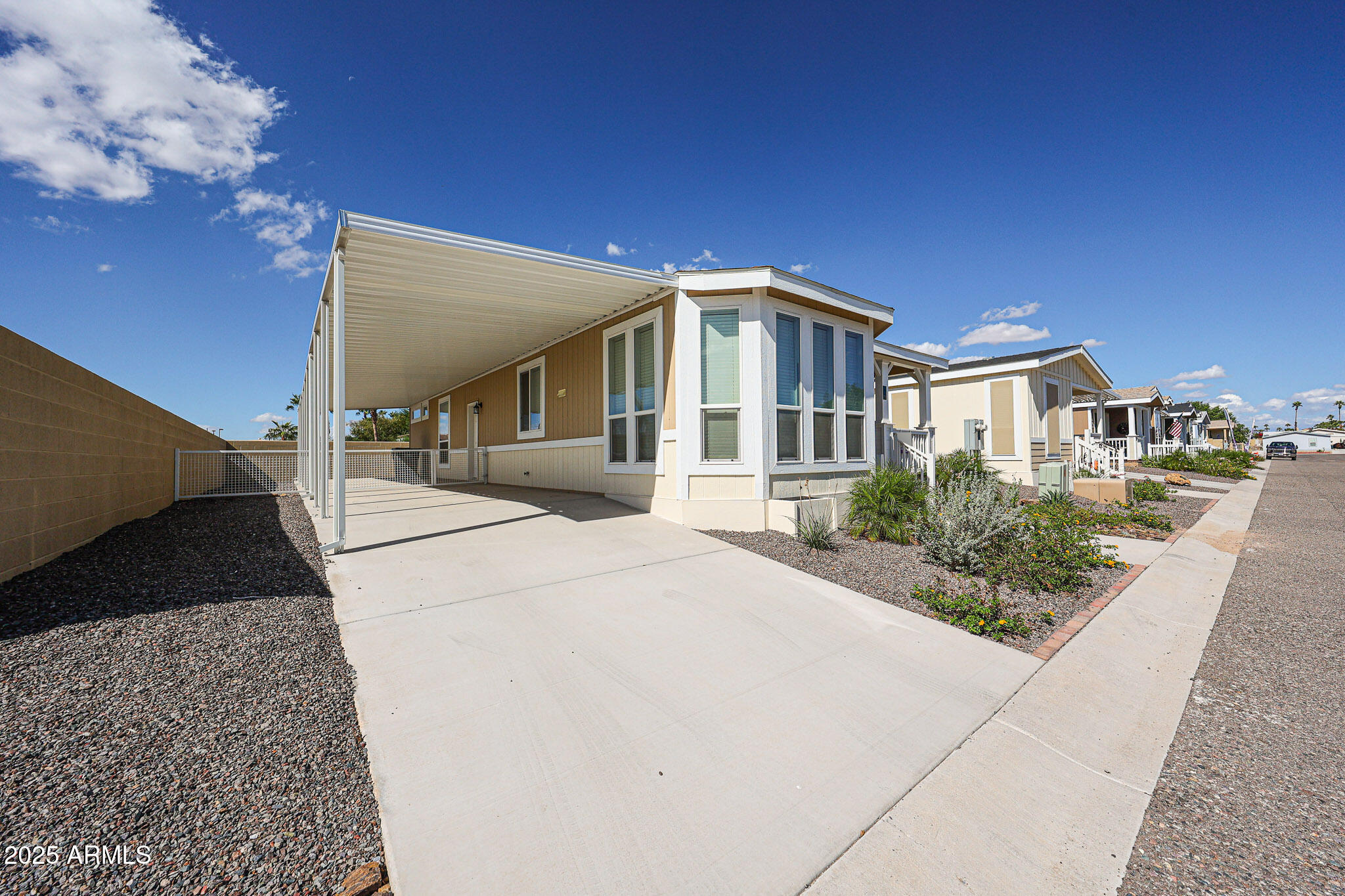 16101 North El Mirage Road, Unit 16 El Mirage, AZ 85335 - Photo 24 of 25 a front view of a house with garden