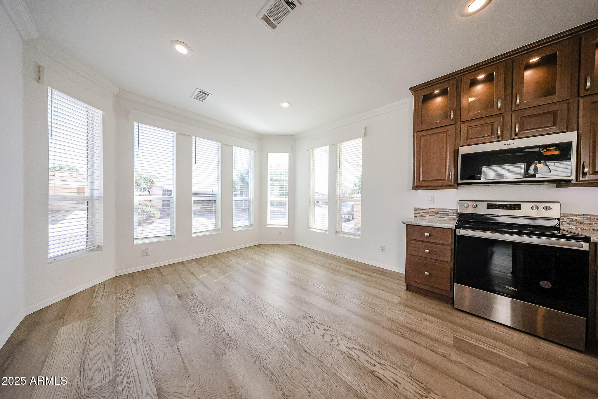 16101 North El Mirage Road, Unit 16 El Mirage, AZ 85335 - Photo 4 of 25 a kitchen with stainless steel appliances a stove sink and microwave