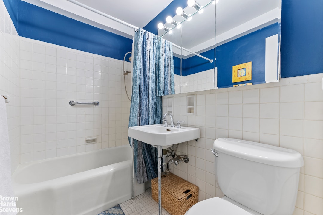 11 Riverside Drive, Unit 13GE Manhattan, NY 10023 - Photo 5 of 12 a bathroom with a sink a toilet and shower