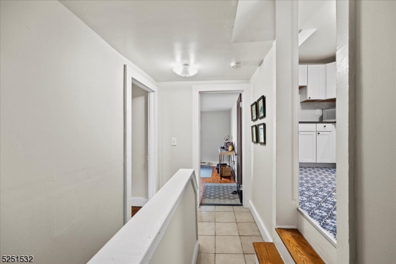 16 Schooleys Mountain Road, Unit 4 Long Valley, NJ 07853 - Photo 5 of 10 a hallway with white cabinets and wooden floor