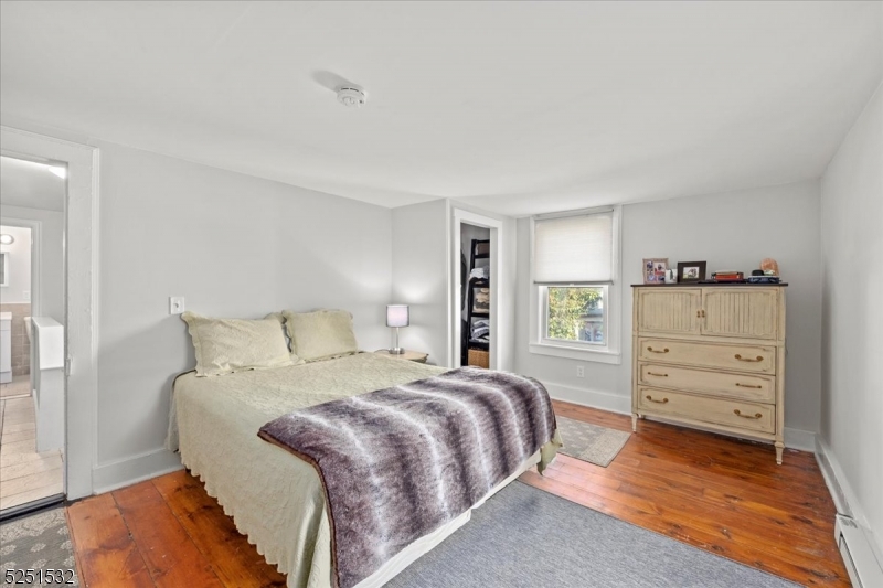 16 Schooleys Mountain Road, Unit 4 Long Valley, NJ 07853 - Photo 6 of 10 a bedroom with a bed and a dresser