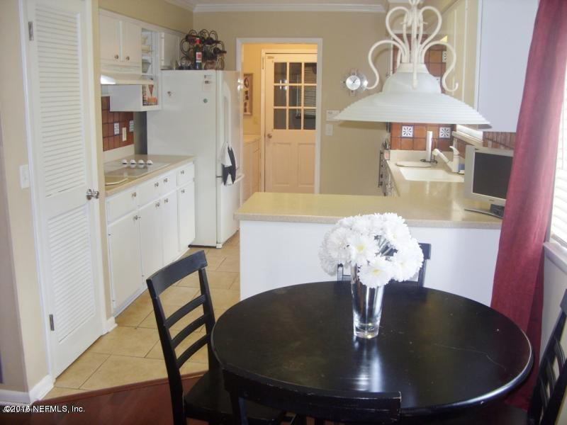 11468 Scott Mill Road Jacksonville, FL 32223 - Photo 11 of 25 a dining room with furniture and wooden floor