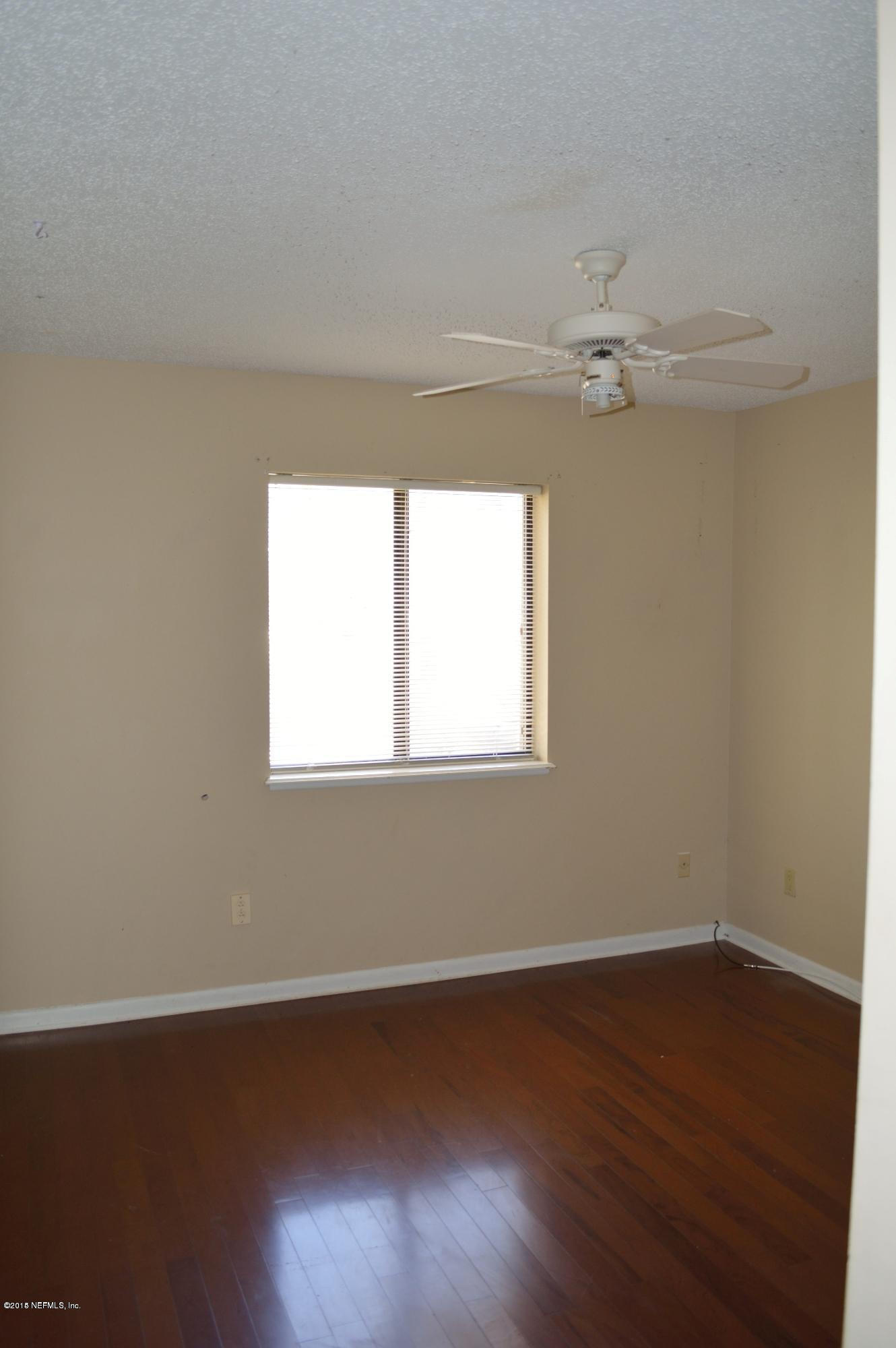 11468 Scott Mill Road Jacksonville, FL 32223 - Photo 14 of 25 a view of a room with wooden floor and fan