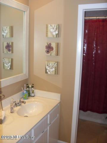 11468 Scott Mill Road Jacksonville, FL 32223 - Photo 15 of 25 a bathroom with a sink and a mirror