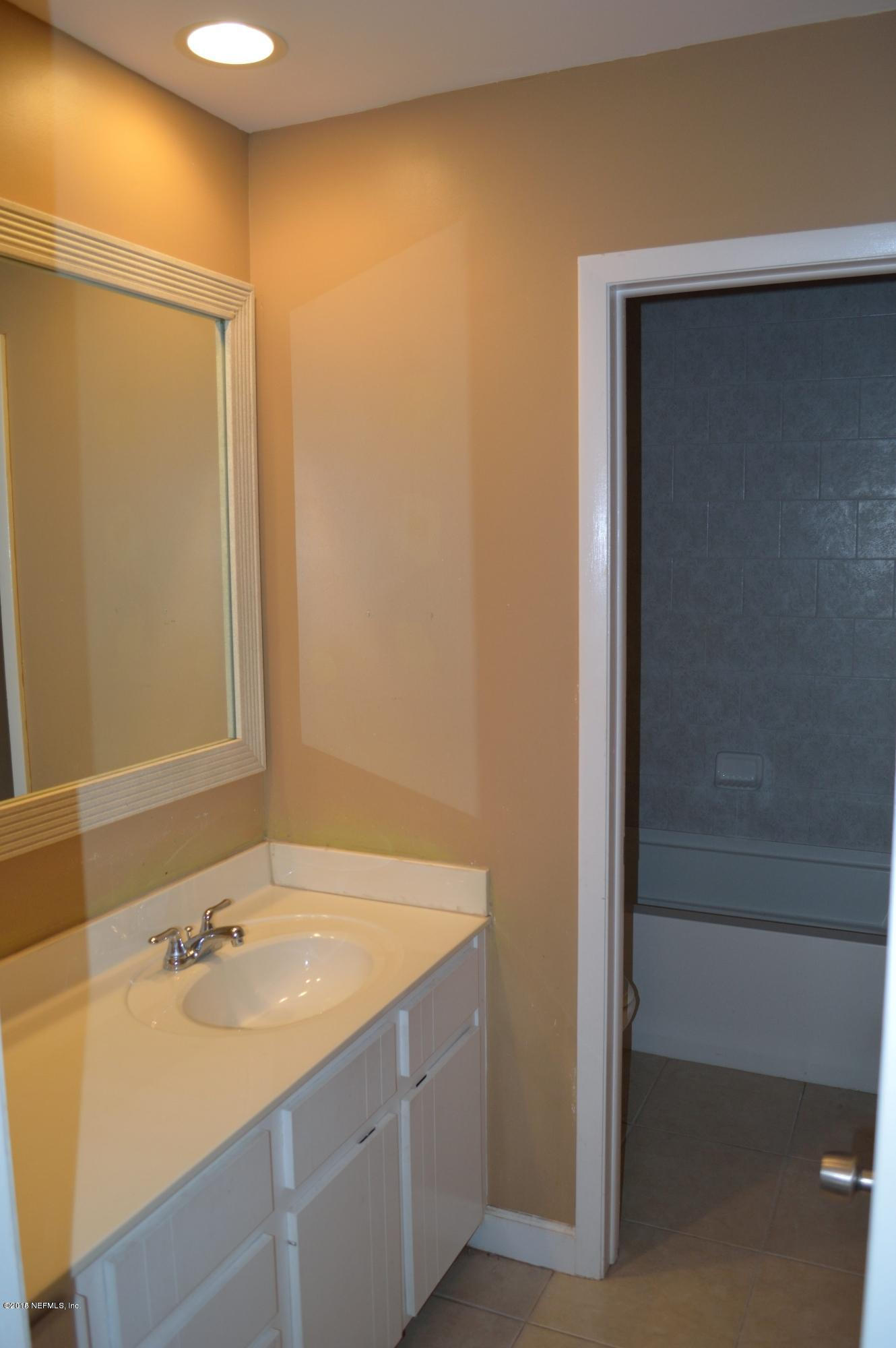 11468 Scott Mill Road Jacksonville, FL 32223 - Photo 16 of 25 a bathroom with a sink and a bathtub