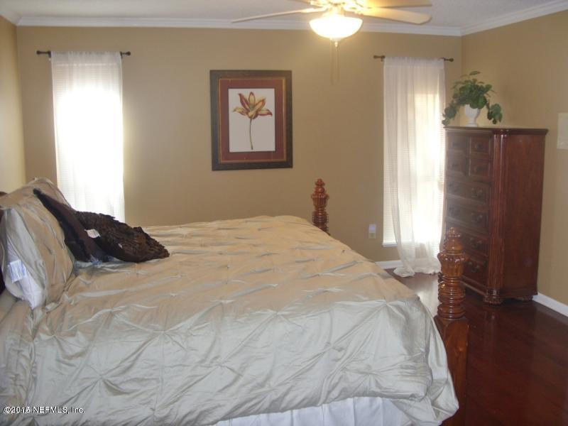 11468 Scott Mill Road Jacksonville, FL 32223 - Photo 18 of 25 a bedroom with a bed and a window